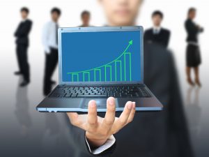 man-showing-growth-graph-in-laptop